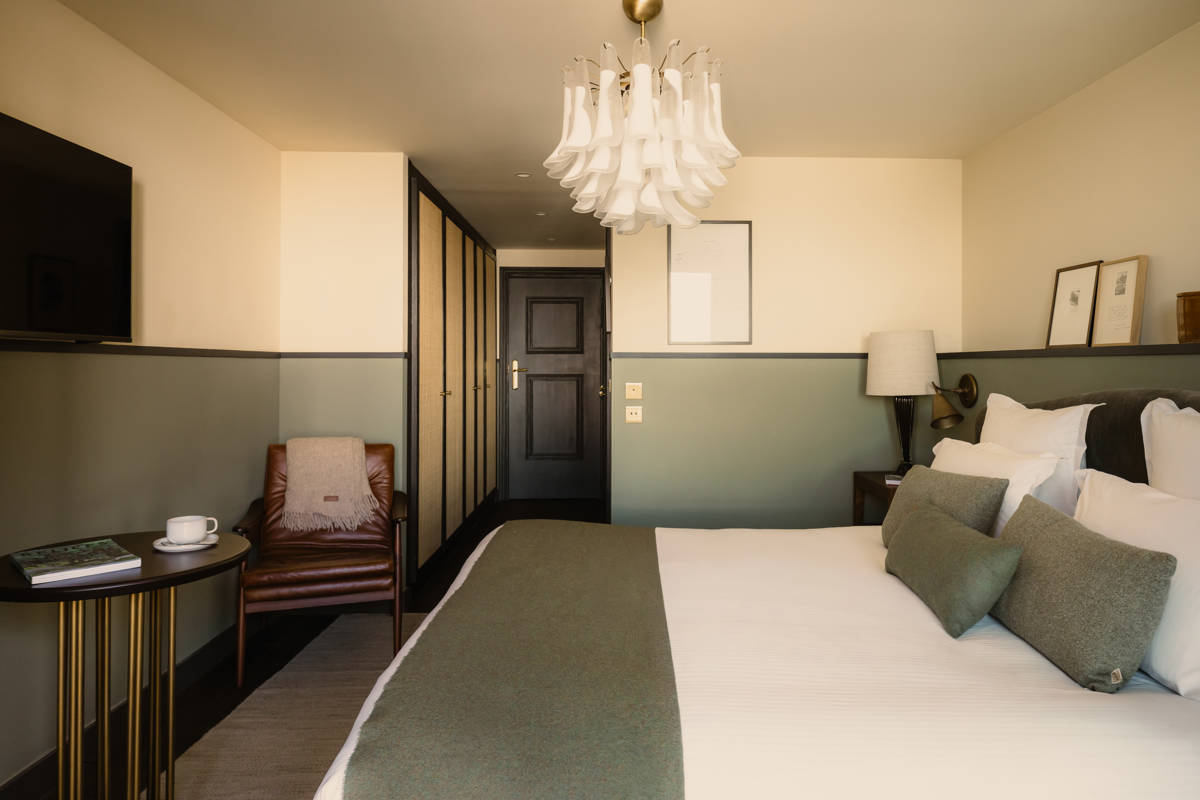 Zimmer im Le Fitz Roy mit Ledersessel, Ankleidebereich und Murano-Glasleuchter