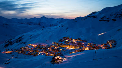 Val Thorens resort illuminated at night in winter, highest ski station in Europe