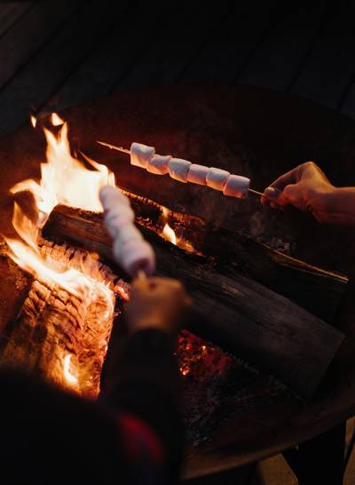 Toasting marshmallows by the fire at the Beaumier hotel L'Alpaga in Megève